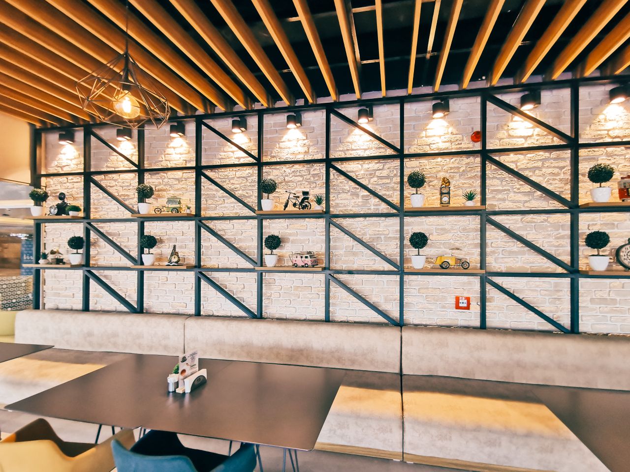 role-01 Chic restaurant interior featuring geometric shelves and modern lighting.